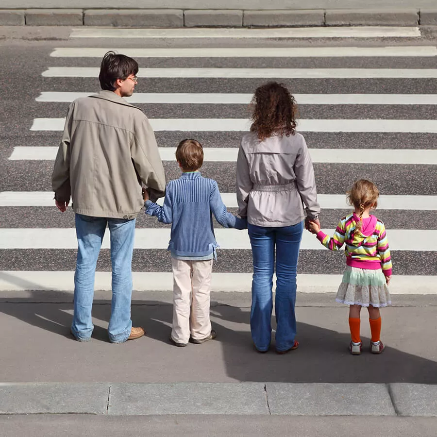 family crossing the road