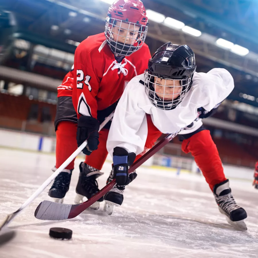 two children playing ice hockey