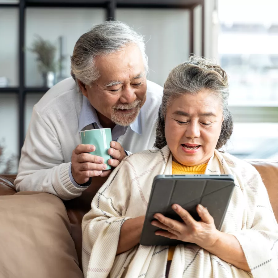 older adults look at a tablet computer