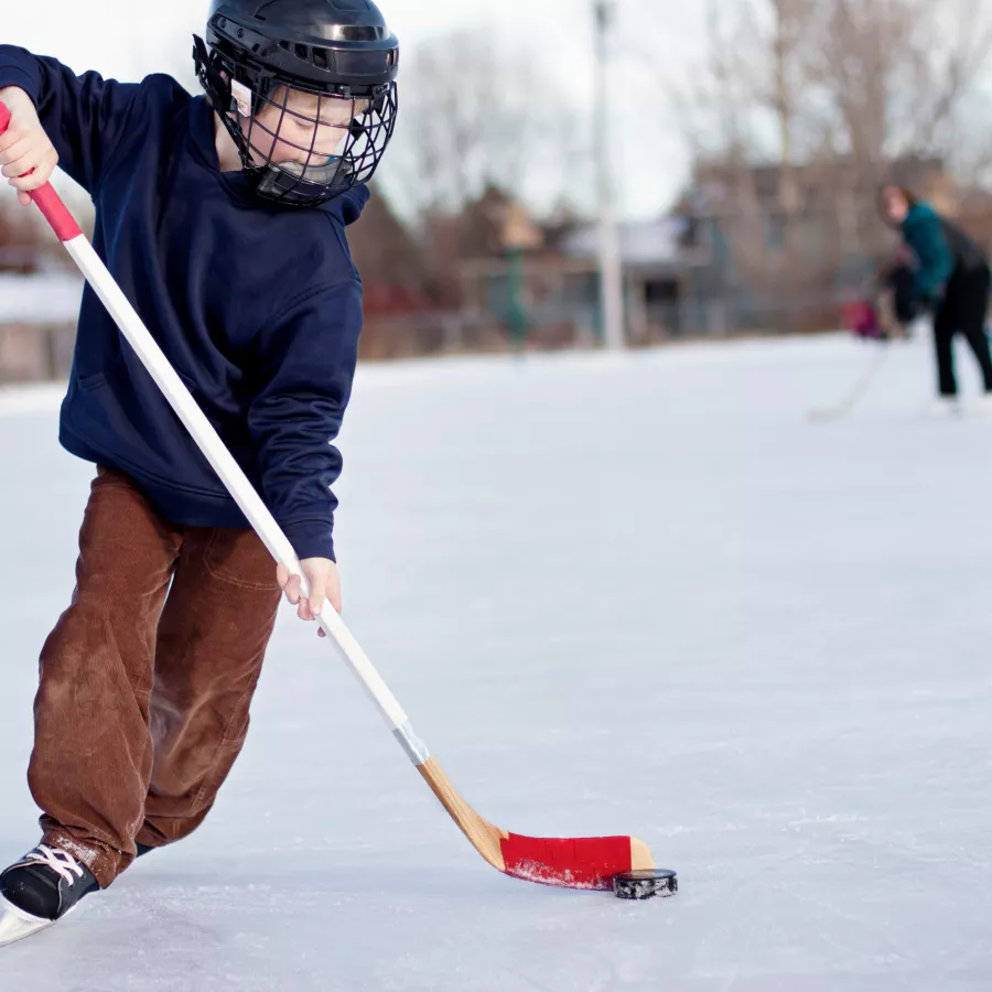 child plays ice hockey